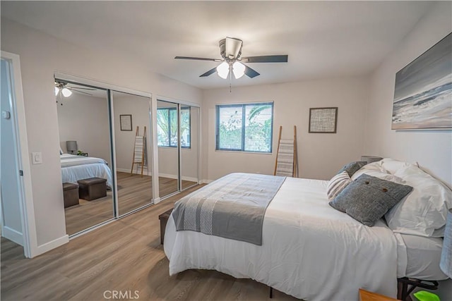 11845 Gladstone Ave, Sylmar, CA 91342 - bedroom with two closets, wood finished floors, baseboards, and ceiling fan