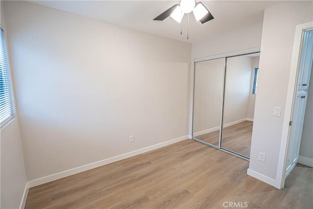 11845 Gladstone Ave, Sylmar, CA 91342 - unfurnished bedroom with light wood-style flooring, a closet, baseboards, and a ceiling fan