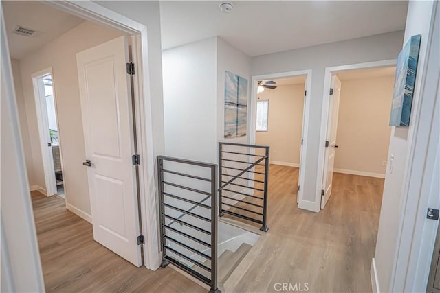 11845 Gladstone Ave, Sylmar, CA 91342 - corridor featuring an upstairs landing, light wood-style floors, and baseboards