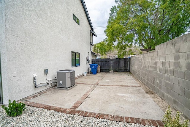 11845 Gladstone Ave, Sylmar, CA 91342 - view of property exterior with stucco siding, a fenced backyard, and a patio area