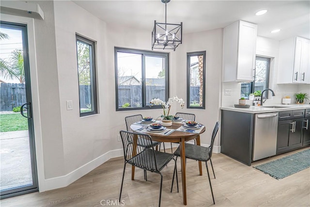 11845 Gladstone Ave, Sylmar, CA 91342 - dining space with light wood-style flooring, baseboards, a chandelier, and recessed lighting