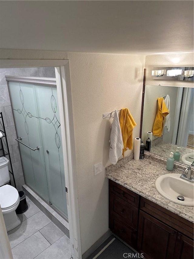 1236 N Columbus Ave Unit 41, Glendale, CA 91202 - full bath featuring toilet, a stall shower, vanity, tile patterned flooring, and baseboards