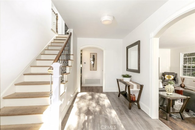 449 Fern Dell Pl, Glendora, CA 91741 - foyer entrance with arched walkways, wood finished floors, stairs, and baseboards