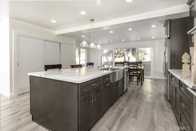449 Fern Dell Pl, Glendora, CA 91741 - kitchen featuring a sink, a large island with sink, light wood finished floors, recessed lighting, and appliances with stainless steel finishes