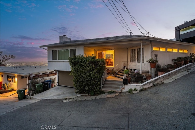 8017 Floral Ave, Los Angeles, CA 90046 - view of front of home with driveway and a chimney