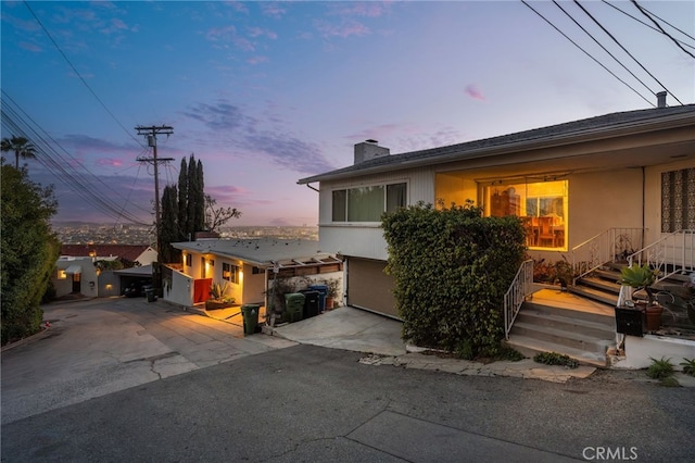 8017 Floral Ave, Los Angeles, CA 90046 - view of front of property with a garage, driveway, and a chimney