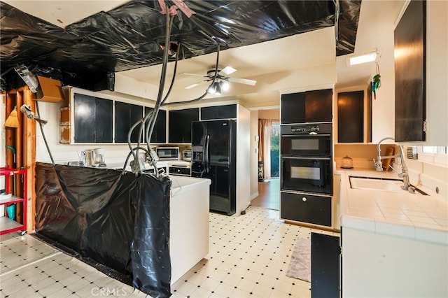 8017 Floral Ave, Los Angeles, CA 90046 - kitchen with light floors, a sink, black appliances, tile counters, and dark cabinets