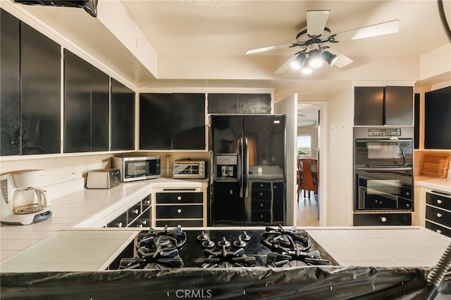 8017 Floral Ave, Los Angeles, CA 90046 - kitchen featuring dark cabinets, black appliances, a ceiling fan, and tile counters