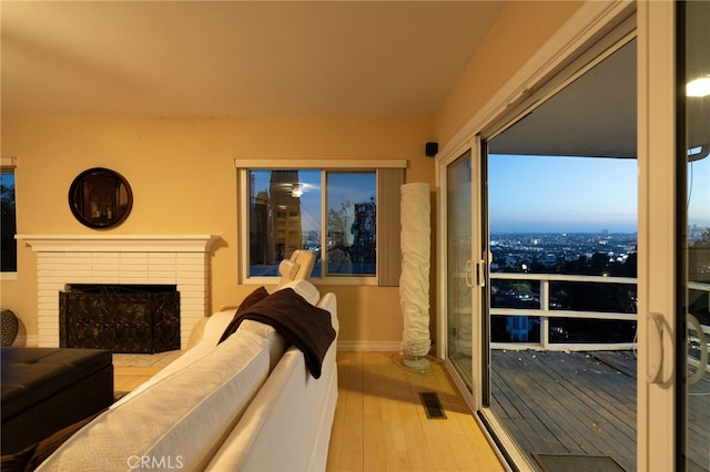 8017 Floral Ave, Los Angeles, CA 90046 - living room with visible vents, a fireplace, baseboards, and wood finished floors