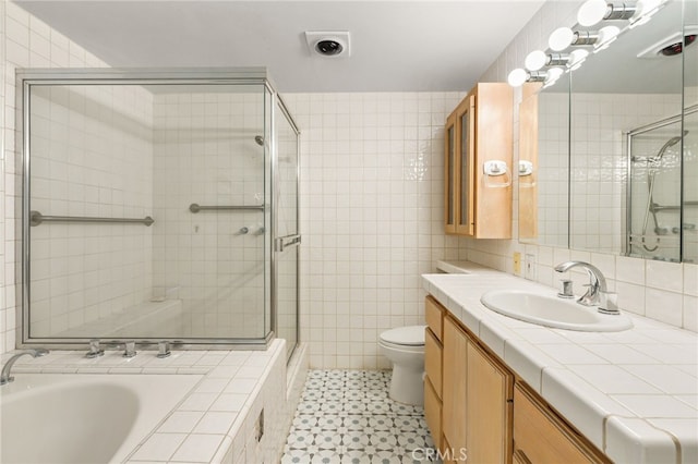 8017 Floral Ave, Los Angeles, CA 90046 - bathroom featuring toilet, a tile shower, tile walls, a relaxing tiled tub, and vanity