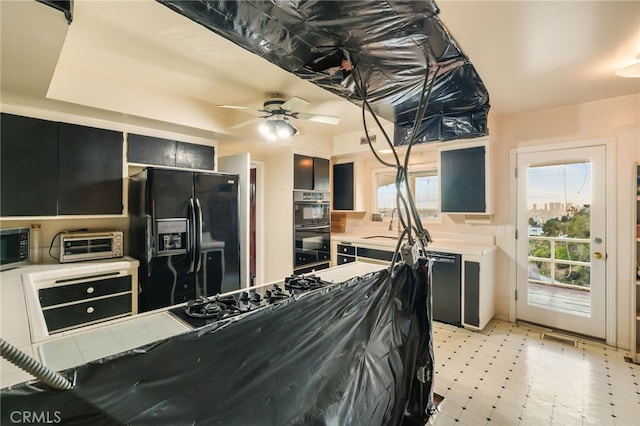 8017 Floral Ave, Los Angeles, CA 90046 - kitchen featuring black appliances, dark cabinetry, a toaster, light floors, and ceiling fan