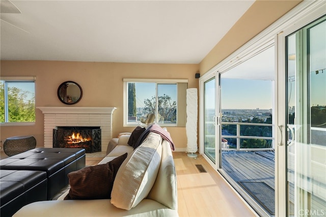 8017 Floral Ave, Los Angeles, CA 90046 - living area with visible vents, wood finished floors, and a fireplace