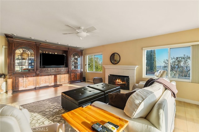 8017 Floral Ave, Los Angeles, CA 90046 - living room featuring baseboards, wood finished floors, a brick fireplace, and ceiling fan