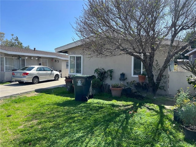 508 W Edinger Ave, Santa Ana, CA 92707 - view of side of home with stucco siding, a yard, and driveway