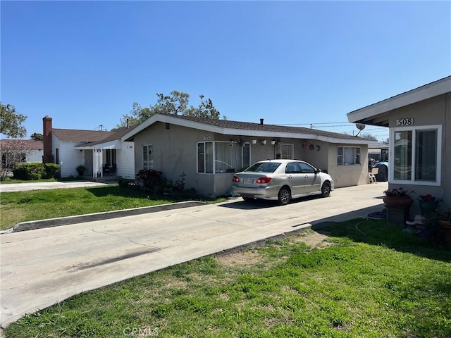 508 W Edinger Ave, Santa Ana, CA 92707 - view of front of home featuring stucco siding, a front lawn, and concrete driveway