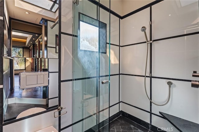 full bathroom with a skylight and a shower stall