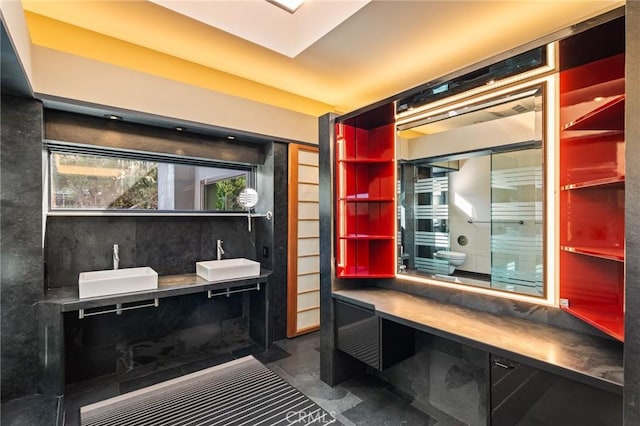 interior space featuring double vanity, finished concrete floors, and a sink