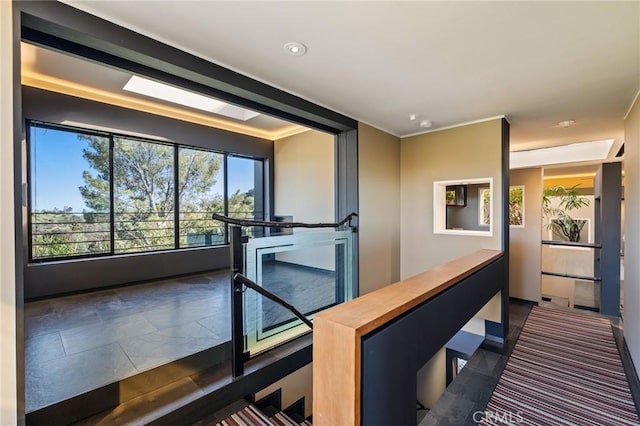 hall featuring an upstairs landing and recessed lighting