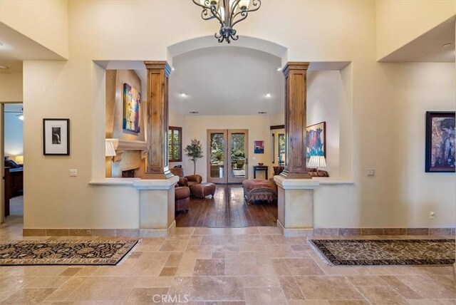 1065 Burnt Rock Way, Templeton, CA 93465 - entrance foyer featuring stone tile floors, baseboards, arched walkways, and ornate columns