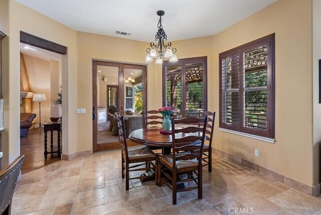 1065 Burnt Rock Way, Templeton, CA 93465 - dining area featuring a notable chandelier, baseboards, stone tile floors, and visible vents