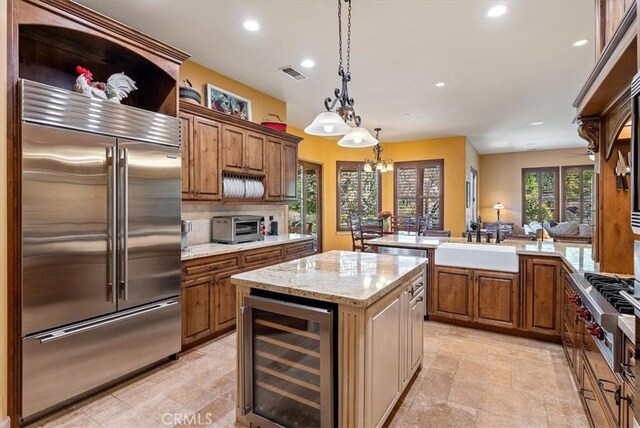 1065 Burnt Rock Way, Templeton, CA 93465 - kitchen featuring brown cabinetry, visible vents, stainless steel appliances, and wine cooler