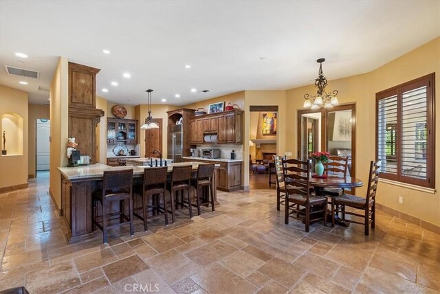 1065 Burnt Rock Way, Templeton, CA 93465 - dining area with visible vents, baseboards, stone tile flooring, and an inviting chandelier