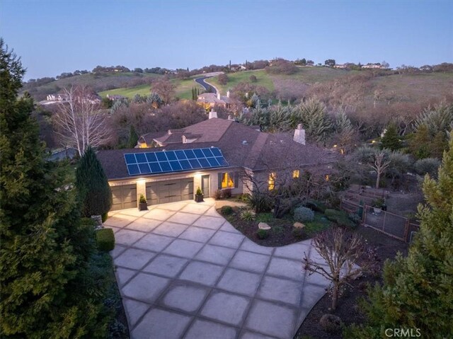 1065 Burnt Rock Way, Templeton, CA 93465 - exterior space featuring an attached garage, roof mounted solar panels, fence, and driveway