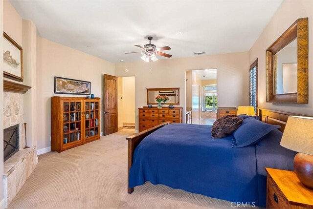 1065 Burnt Rock Way, Templeton, CA 93465 - carpeted bedroom featuring baseboards, visible vents, a fireplace with raised hearth, and ceiling fan
