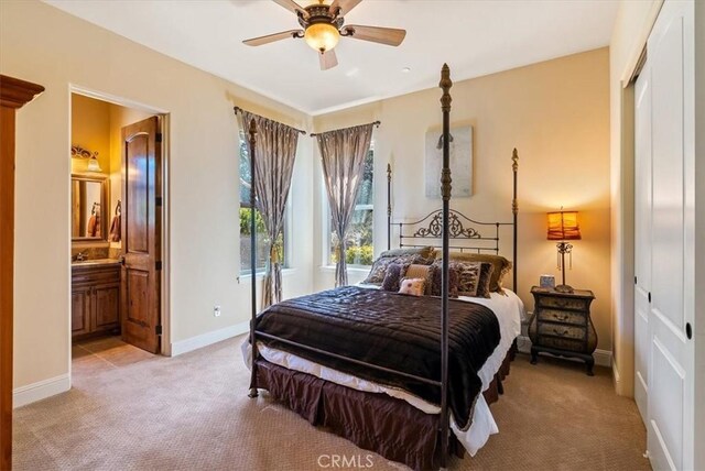 1065 Burnt Rock Way, Templeton, CA 93465 - bedroom with a closet, connected bathroom, ceiling fan, light colored carpet, and baseboards