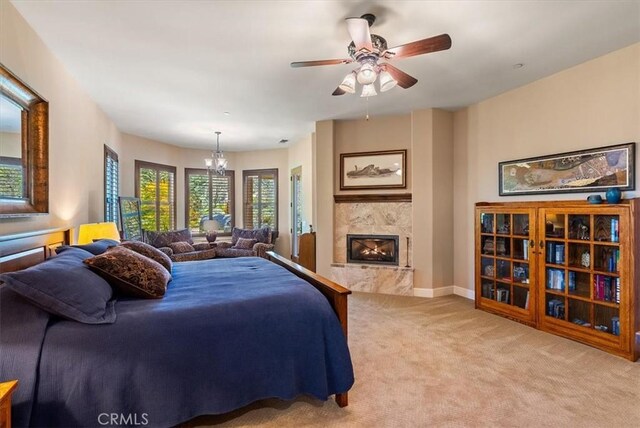 1065 Burnt Rock Way, Templeton, CA 93465 - bedroom featuring a fireplace, baseboards, light colored carpet, and ceiling fan with notable chandelier