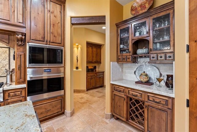 1065 Burnt Rock Way, Templeton, CA 93465 - kitchen featuring tasteful backsplash, light stone counters, black microwave, oven, and glass insert cabinets