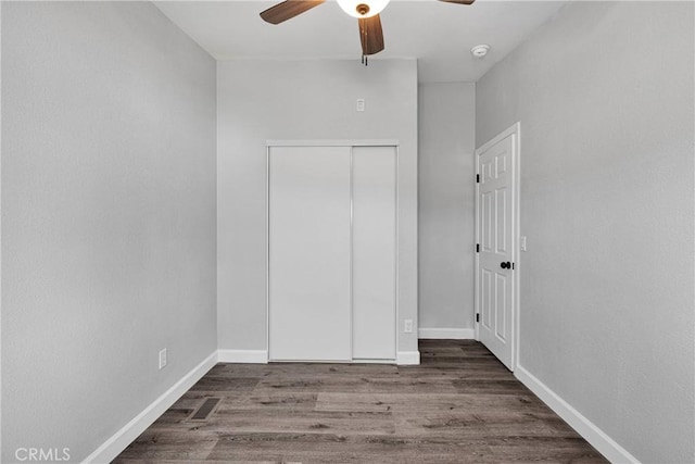 36090 Old Woman Springs Rd, Lucerne Valley, CA 92356 - unfurnished bedroom with a closet, baseboards, and wood finished floors
