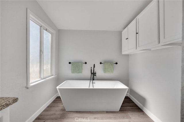 36090 Old Woman Springs Rd, Lucerne Valley, CA 92356 - bathroom featuring wood finished floors, baseboards, and a wealth of natural light