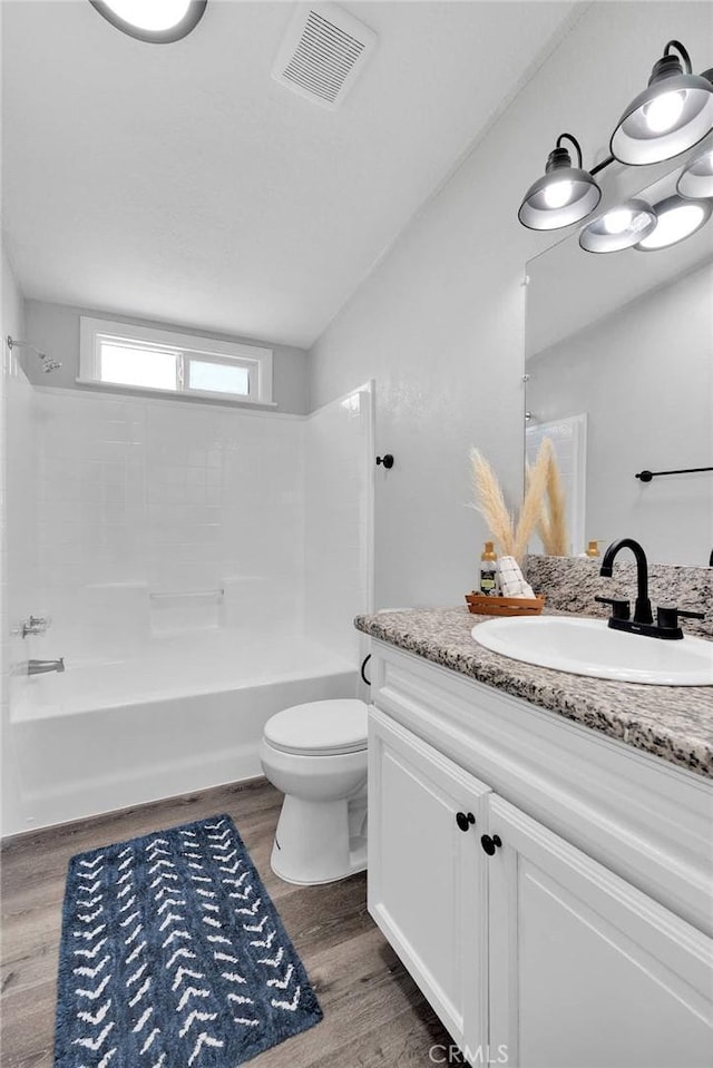 36090 Old Woman Springs Rd, Lucerne Valley, CA 92356 - full bath with vanity, wood finished floors, visible vents, shower / bathing tub combination, and toilet
