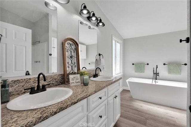 36090 Old Woman Springs Rd, Lucerne Valley, CA 92356 - full bathroom with a freestanding bath, vaulted ceiling, wood finished floors, and a sink