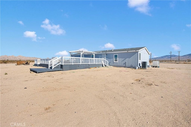 36090 Old Woman Springs Rd, Lucerne Valley, CA 92356 - back of property with cooling unit, a mountain view, and a pergola