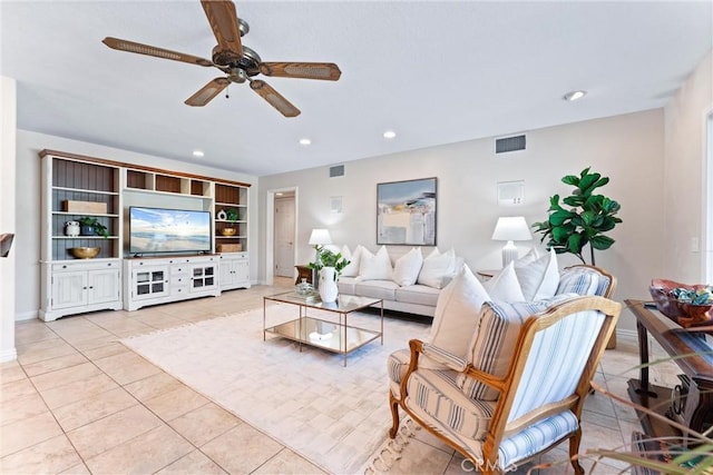living area featuring light tile patterned flooring, a ceiling fan, recessed lighting, and baseboards