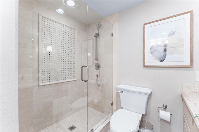 full bath featuring vanity, a stall shower, and toilet