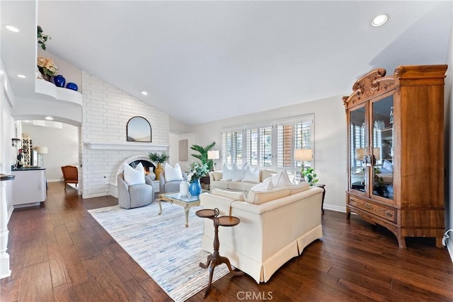 living area with vaulted ceiling, dark wood-style floors, a fireplace, recessed lighting, and baseboards