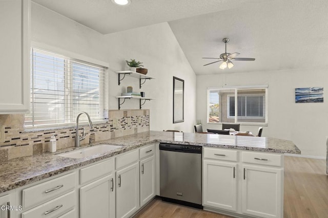 5125 W Wooley Rd Unit 5, Oxnard, CA 93035 - kitchen featuring dishwasher, a peninsula, vaulted ceiling, a ceiling fan, and white cabinets