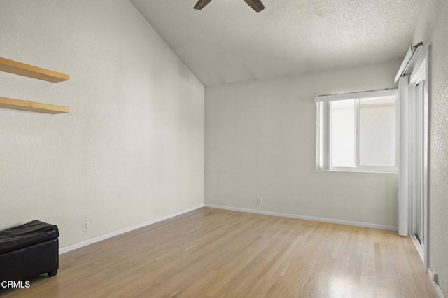 5125 W Wooley Rd Unit 5, Oxnard, CA 93035 - spare room featuring wood finished floors, a ceiling fan, a textured ceiling, and vaulted ceiling