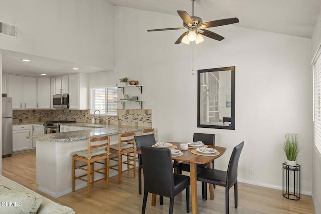 5125 W Wooley Rd Unit 5, Oxnard, CA 93035 - dining space with high vaulted ceiling, light wood-style floors, a ceiling fan, and recessed lighting