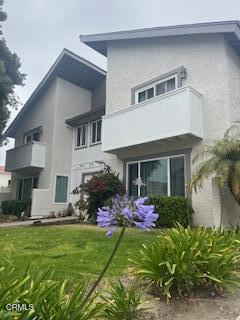 5125 W Wooley Rd Unit 5, Oxnard, CA 93035 - rear view of house featuring a balcony and stucco siding