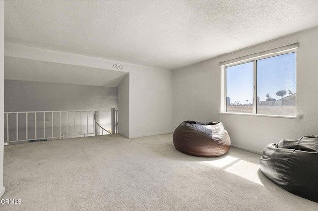 5125 W Wooley Rd Unit 5, Oxnard, CA 93035 - sitting room with an upstairs landing, carpet, and a textured ceiling