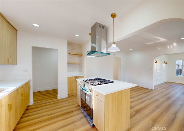 kitchen with range hood, open shelves, light wood-style flooring, arched walkways, and range with gas cooktop