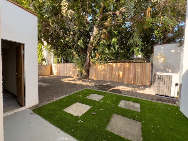 view of yard featuring central AC and a fenced backyard