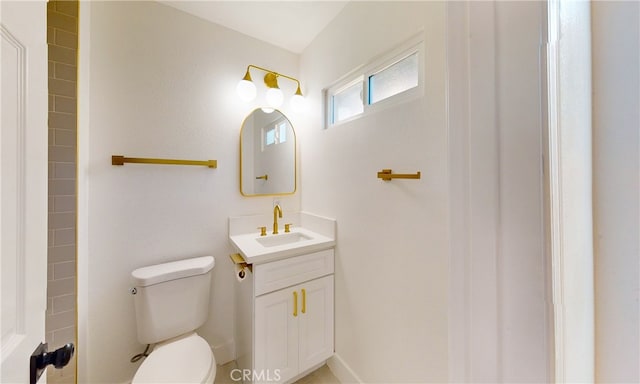 bathroom featuring toilet and vanity