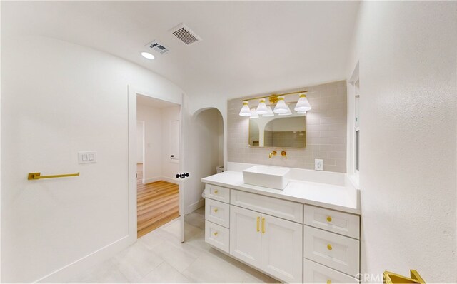 bathroom with tile patterned floors, visible vents, baseboards, and vanity