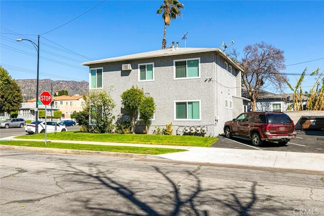 view of front of house featuring stucco siding and a front yard