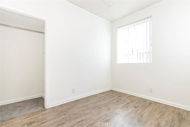 unfurnished bedroom featuring baseboards and wood finished floors